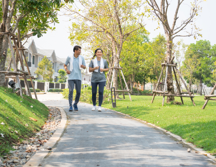 Couple walking along a park trail near Meadows Apartments - Universal City, TX